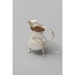 A GEORGE III SILVER CREAMER, LONDON 1736, WALTER BRIND, wavy rim, C-scroll handle, tapered body,