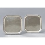 A PAIR OF SILVERPLATE TRAYS, MADE IN ENGLAND, of square form, applied inverted border, plain well,