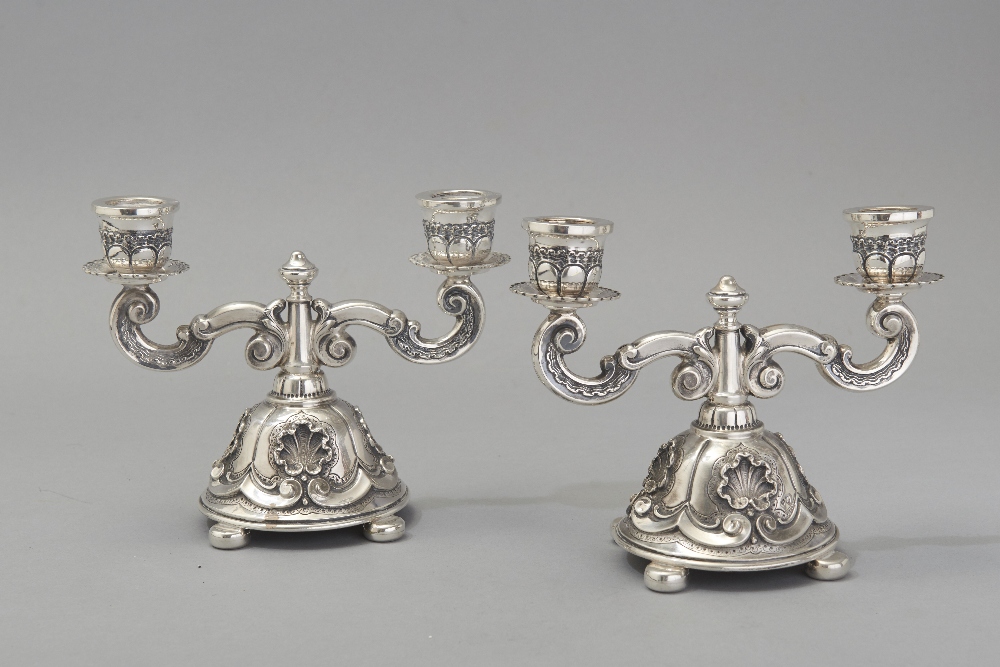A PAIR OF .833 STD PORTUGUESE SILVER TWO-ARM CANDELABRA, the entire piece embossed with shells,