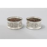 A PAIR OF .800 STD CONTINENTAL SILVER BOTTLE COASTERS, fold-over rim, the body embossed with putti'