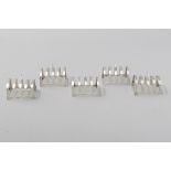 A SET OF FOUR GEORGE VI SILVER TOAST RACKS, BIRMINGHAM 1940, L. Ltd., the four-section curved-shaped