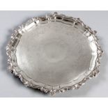 A VICTORIAN SILVER SALVER, SHEFFIELD 1899, H.A., of circular form, the rim embossed with shells