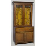 A GEORGE III MAHOGANY CABINET BOOKCASE, the upper section with a moulded swept pediment above two