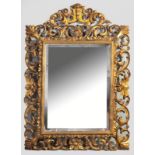 A LARGE RECTANGULAR BEVELLED MIRROR, set in a gilt rococo-style frame, the ornate corners and