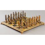 A FINELY CAST METALLIC CHESS SET, depicting classical Roman and Greek figures, standing on a