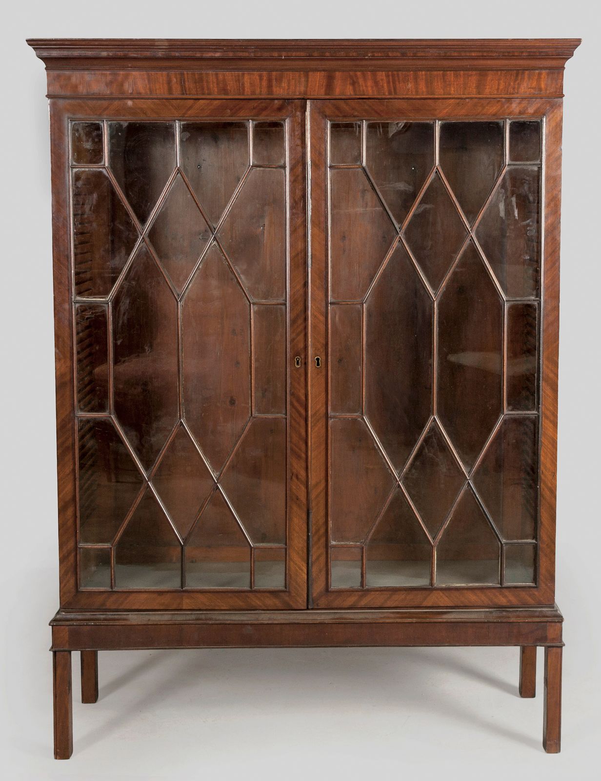 A GEORGE III MAHOGANY BOOKCASE, the moulded top above twin astragal moulded glazed doors, standing