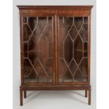 A GEORGE III MAHOGANY BOOKCASE, the moulded top above twin astragal moulded glazed doors, standing