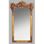 A RECTANGULAR MIRROR, mounted in a simulated gilt-frame, the top-rail decorated in high relief