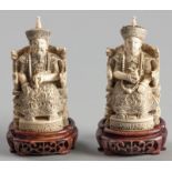A PAIR OF CARVED CHINESE IVORY FIGURES OF A MANDARIN AND HIS WIFE, LATE 20th CENTURY, seated on
