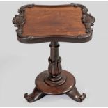 AN EARLY VICTORIAN MAHOGANY TRAY TABLE, the carved serpentine top on a baluster stem decorated