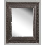 A RECTANGULAR BEVELLED MIRROR, set in a composite frame decorated with ribbons and floral