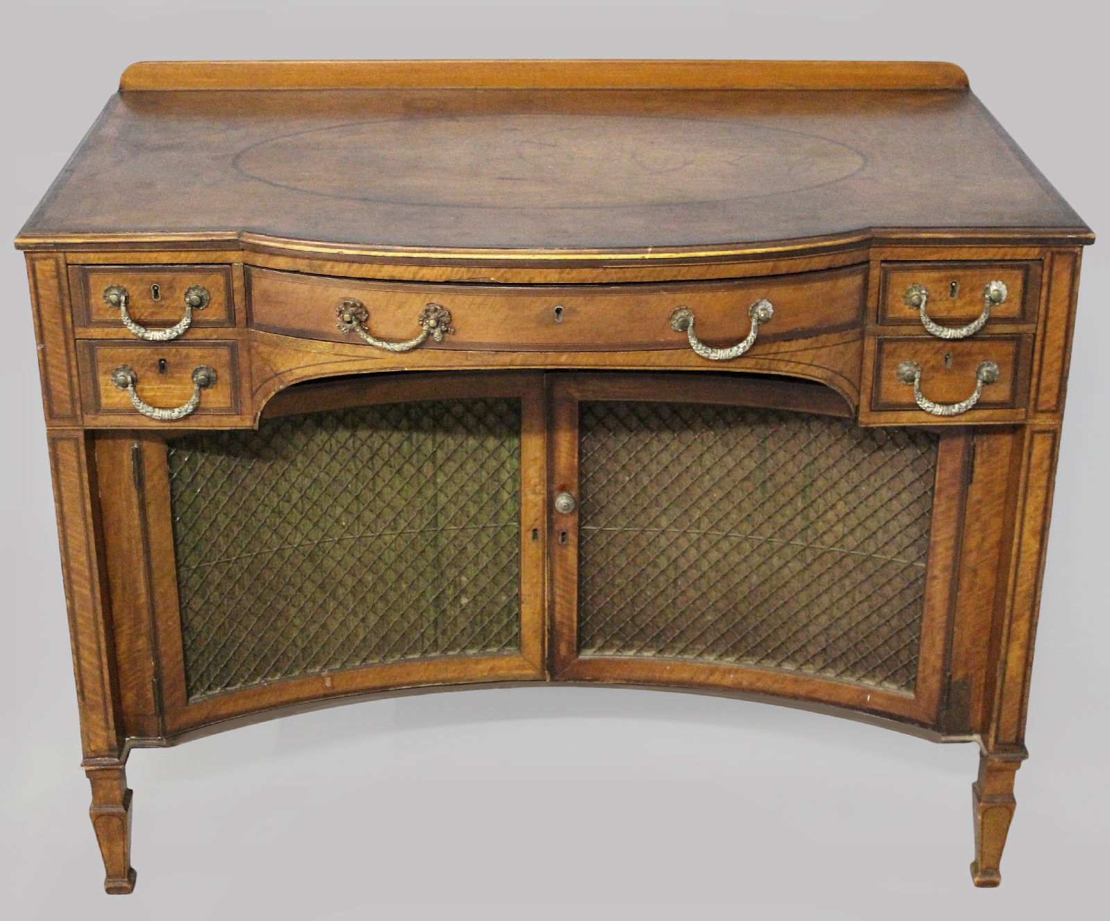 AN EDWARDIAN MAHOGANY AND INLAID BUFFET, the bowed top with an oval inlay and stringing above a