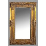 A LARGE RECTANGULAR MIRROR, set in a gold painted frame, the top-rail decorated with acanthus leaves