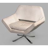 A CONTEMPORARY ROTATING ARMCHAIR, of geometric form covered in cream leather (slight stains),