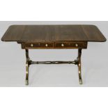 A REGENCY MAHOGANY SOFA TABLE, the strung top with drop leaves above two drawers and a dummy drawer,