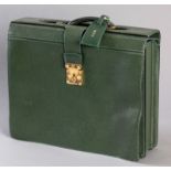 A LOUIS VUITTON GREEN LEATHER EXPANDING ATTACHÉ CASE, the interior fitted with various compartments,