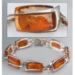 AN AMBER AND STERLING SILVER BRACELET, comprising of seven rectangular form amber beads, with hoop