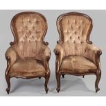 A NEAR PAIR OF VICTORIAN MAHOGANY ARMCHAIRS, the hooped backs above close-buttoned upholstery, the