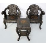 A PAIR OF 20th CENTURY HARDWOOD ARMCHAIRS, the backs and arms depicting dragons, some with captive