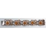 A STERLING SILVER, 14ct YELLOW GOLD AND CITRINE BRACELET, comprising of five rectangular form links,