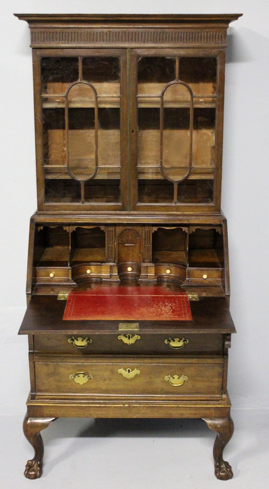 A GEORGE III MAHOGANY BUREAU BOOKCASE, the upper section with a swept pediment and fluted frieze