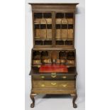 A GEORGE III MAHOGANY BUREAU BOOKCASE, the upper section with a swept pediment and fluted frieze