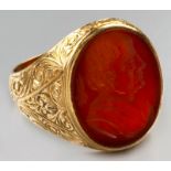 AN 18ct YELLOW GOLD AND CARNELIAN SIGNET RING, carnelian engraved with a man in profile, 14.4g.