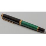 A PELIKAN SOUVERAN FOUNTAIN PEN, the green ribbed wide bodied cartridge below an 18ct gold nib,