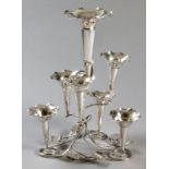 A SILVERPLATE EPERGNE, composed of seven removable trumpet vases, on a scroll and leaf decorated