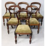 A SET OF SIX VICTORIAN MAHOGANY BUSTLE BACK DINING CHAIRS, the hooped backs with floral carved