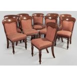 A SET OF TEN VICTORIAN MAHOGANY DINING CHAIRS, the hooped backs above rouge upholstery, with