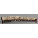 A CHINESE IVORY CARVED AND PIERCED TUSK, MID-19th CENTURY, with pairs of figures seated amongst
