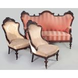 AN EDWARDIAN CARVED MAHOGANY THREE PIECE SUIT, the camel-back settee with striped upholstery,