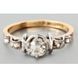 AN 18ct WHITE GOLD, YELLOW GOLD AND DIAMOND RING, with a centre claw-set brilliant cut diamond of