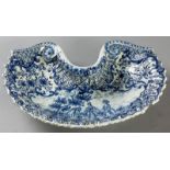 AN 18th CENTURY DUTCH DELFT BARBER'S BOWL, of fluted shell form of ladies in a landscape, from the
