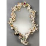 A 19th CENTURY GERMAN PORCELAIN MIRROR IN ROCOCO STYLE, with cherubs playing madolins and