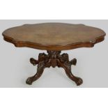 A MID-VICTORIAN BURR WALNUT AND WALNUT OVAL TABLE, the moulded serpentine top and frieze standing on