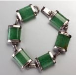 A STERLING SILVER AND JADE BRACELET, comprising of six rectangular silver capped jade beads, with