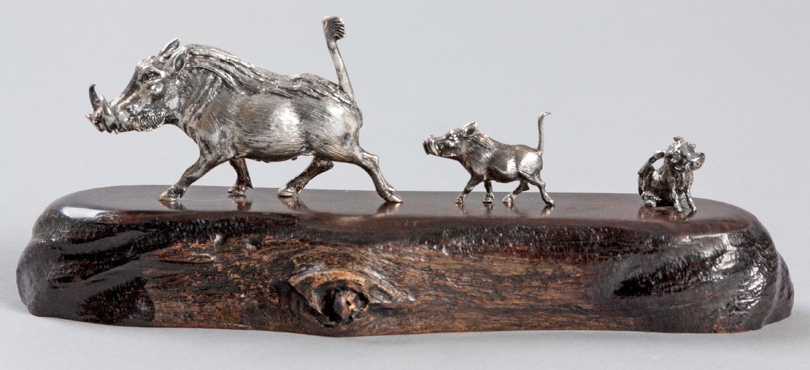 A PATRICK MAVROS SILVER SCULPTURE, of a female warthog with her two piglets, mounted on a