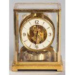 A JEAGER-LE-COULTRE ATMOS CLASSIQUE WHITE DIAL BRASS DESK CLOCK, of rectangular form with a yellow