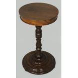 A VICTORIAN-STYLE MAHOGANY LAMP TABLE, the circular top above a turned column, standing on a moulded