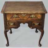 A GEORGE II WALNUT VENEERED LOW BOY, the stripped oak top above a single drawer with later lining