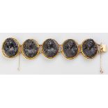 A BLACK LAVA AND PINCHBECK CAMEO BRACELET, the five oval shape cameo's carved in high relief,