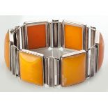 A SILVER AND BUTTERSCOTCH AMBER BRACELET, the rectangular amber set in silver framework