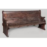 A LATE 19TH CENTURY STAINED HARDWOOD PEW, the sides of slightly different design, standing on sleigh