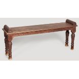 AN EDWARDIAN MAHOGANY WINDOW SEAT, the moulded top with half-round ends above a reeded frieze with