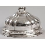 A SILVERPLATE MEAT DOME, the removable handle embossed with flowers and scrolls, segmented body