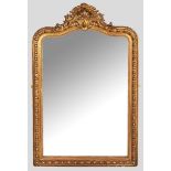A VICTORIAN GILT FRAMED MIRROR, the arched plate set within a beaded egg-and-posy border, the top-