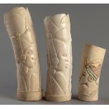 A PAIR OF CARVED AFRICAN IVORY TUSKS, depicting the profiles of African women and elephants,