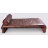 A RIBBED LEATHER DAYBED, the monocoque-shape with wooden baton foot-rest, the lower surface with